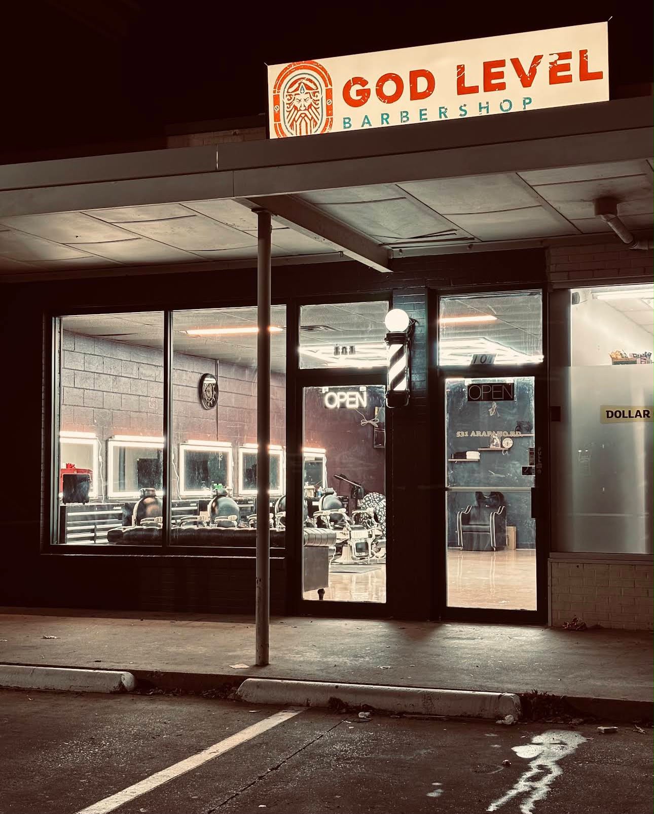 God Level Barbershop storefront at night